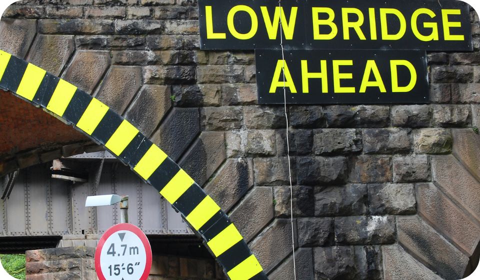 static hazard low bridge and 'low bridge ahead' sign