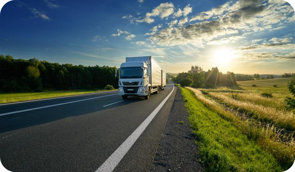 white lorry driving on road