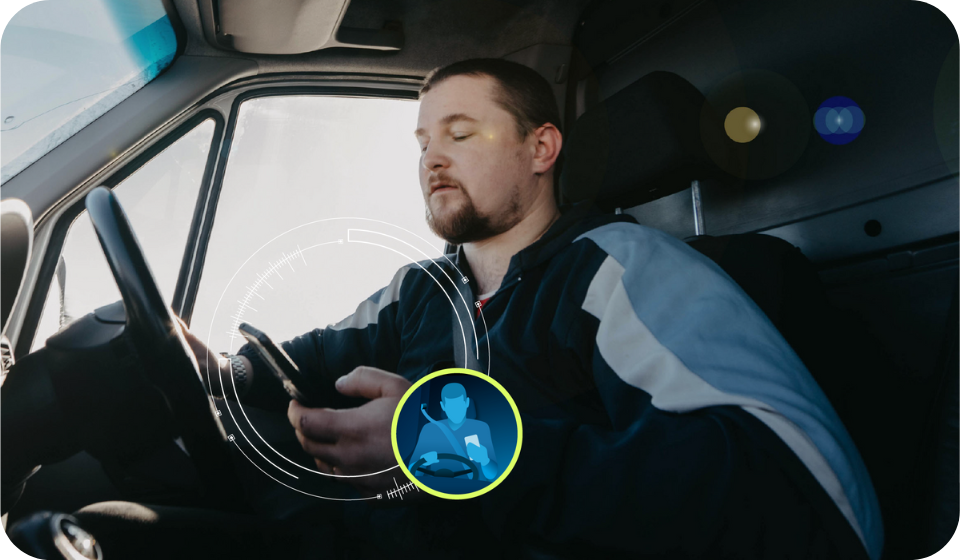 man looking down and using phone while driving